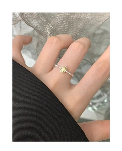 Close-up of S925 silver ring with oval green zircon and unique bubble texture band