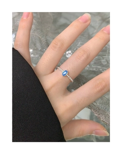 Detailed close-up of S925 silver beaded ring featuring a blue oval zircon on a hand