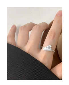 Close-up of polished S925 sterling silver heart-shaped open ring worn on a finger
