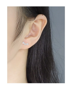 Detail of S925 sterling silver heart earrings shown on a model for scale and style