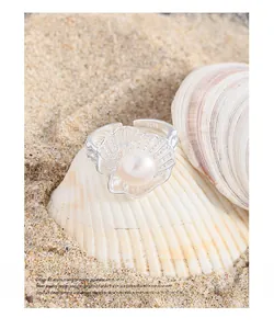 Detailed view of S925 sterling silver shell ring with white pearl and small diamonds