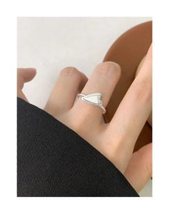 Close-up of minimalist S925 sterling silver heart-shaped open ring worn on a finger