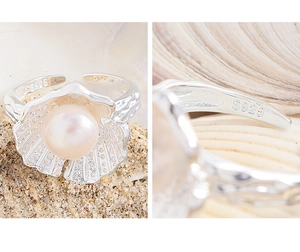 Macro detail of S925 sterling silver stamp and shell pearl design on an open ring