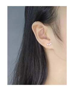 Detail view of heart-shaped S925 sterling silver stud earrings worn on female ear