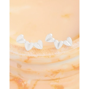 Minimalist S925 sterling silver heart earrings with textured metallic finish on marble