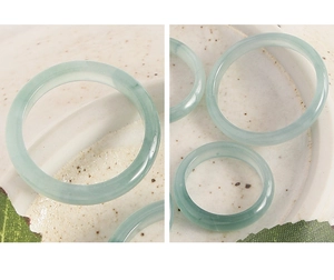 Macro view of minimalist light green natural jade rings with polished round texture