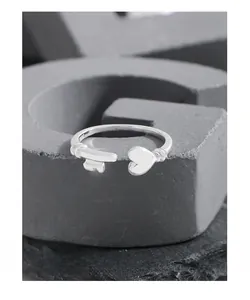 Detailed shot of S925 sterling silver open ring with key and heart motif on stone