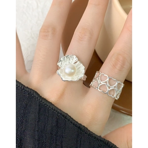 Minimalist S925 silver rings with shell pearl and hollow heart design on a hand