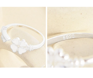 Macro detail of S925 sterling silver stamp and clover ring texture on stone background