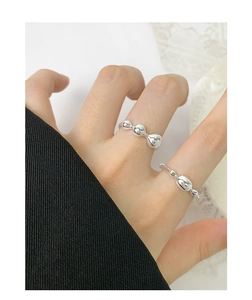 Close-up of S925 sterling silver rings featuring liquid-style polished metal spheres