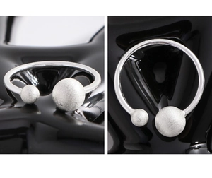 Detail of S925 sterling silver open ring featuring matte spheres and polished finish