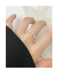 Detail of S925 silver open ring with heart and T-bar design worn on model finger