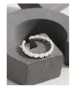 Macro detail of S925 sterling silver ring with continuous floral relief pattern