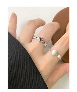 Close-up of S925 sterling silver ball ring with heart-cut magenta gemstone jewelry