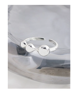 Macro shot of polished S925 silver open ring featuring three minimalist gradient beads