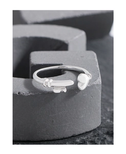 Detail of S925 sterling silver open ring with unique heart and key interlocking design