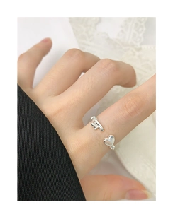 Detail of silver S925 heart open ring worn by model showing minimalist asymmetric design