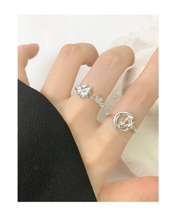 Close-up of S925 sterling silver ring set with clover and cherry charms on hand