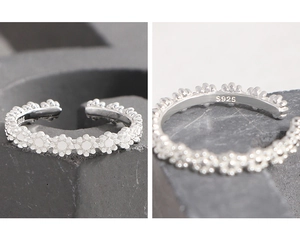 Macro detail of S925 sterling silver stamp and continuous daisy floral ring design