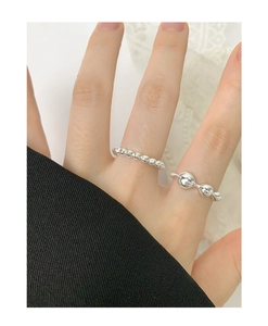 Close-up of S925 sterling silver beaded and irregular liquid ball open rings on hand