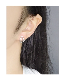 Detail of S925 silver stud earring with irregular melting texture worn on ear