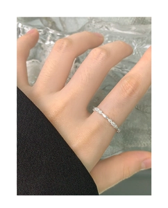 Close-up of S925 sterling silver floral ring with beaded texture worn on female finger