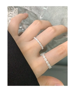 Close-up of S925 sterling silver flower ring set worn by model in a soft elegant setting