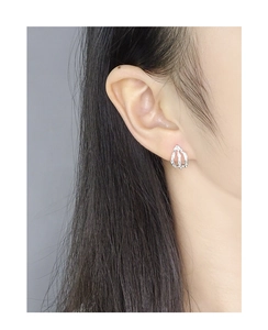 Close-up of S925 silver stud earring with irregular molten texture on female ear