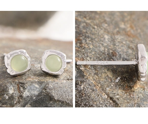 Macro detail of S925 sterling silver earrings with green gemstone and hammered texture