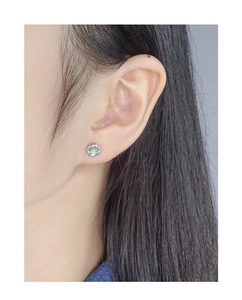 Close-up of S925 sterling silver square stud earrings with light green crystal stone