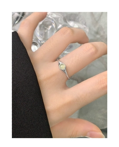 Close-up of S925 silver ring featuring a light green crystal on a slender band