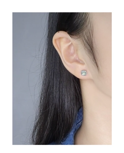 Detail view of silver S925 square earring featuring a round light green crystal gemstone