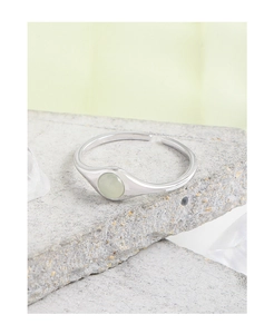 Macro detail of S925 sterling silver ring featuring a round green jadeite gemstone