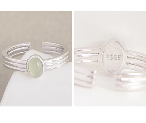 Macro shot of S925 sterling silver hallmark and green crystal inlay detail