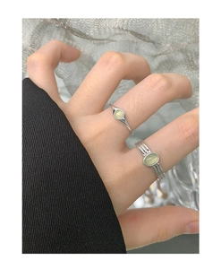 Macro shot of S925 silver ring with light green crystal gemstone on model hand