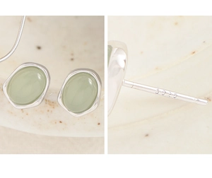 Macro detail of S925 sterling silver stamp and green crystal stone earring