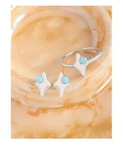 Detailed close-up of S925 sterling silver starburst earrings with blue opal inlay