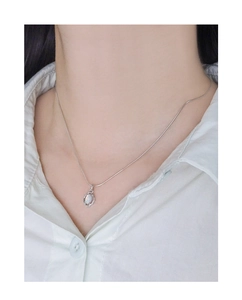 Close-up of S925 silver snake chain with minimalist opal wreath pendant on a model