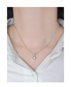 Close-up of S925 sterling silver opal pendant necklace worn on neck with snake chain
