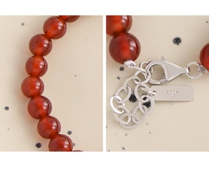 Detail shot of S925 sterling silver lobster clasp and red agate beads on minimalist bracelet