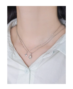 Detail of S925 sterling silver layered necklace with opal pendant and star on snake chain