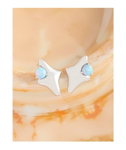 Macro shot of S925 silver star stud earrings with blue opal on marble surface
