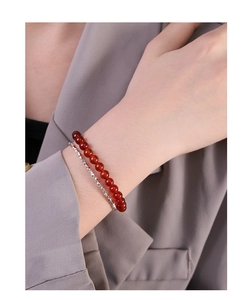Macro view of double-layer S925 silver beaded bracelet with red agate beads on wrist