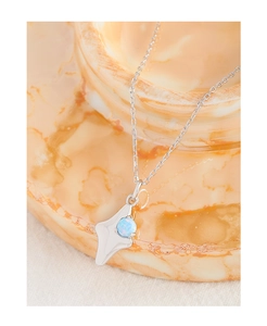 Macro view of S925 silver necklace with fluid pendant and blue opal gemstone