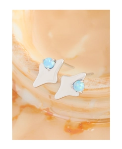 Macro shot of S925 silver starburst stud earrings featuring blue round opal stones