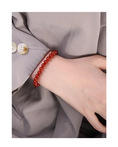 Macro shot of minimalist red agate beaded S925 sterling silver bracelet for women