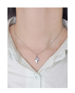 Close-up of S925 silver star pendant with blue opal stone on female model neck