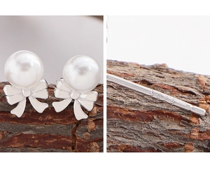 Detailed view of S925 sterling silver bow earrings with elegant white pearls and hallmark