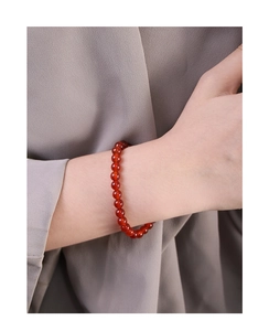 Close-up of a minimalist 6mm red agate beaded bracelet on a woman wrist with S925 silver