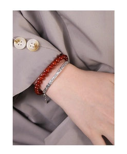 Detail of red agate beaded bracelet paired with textured S925 sterling silver bangle